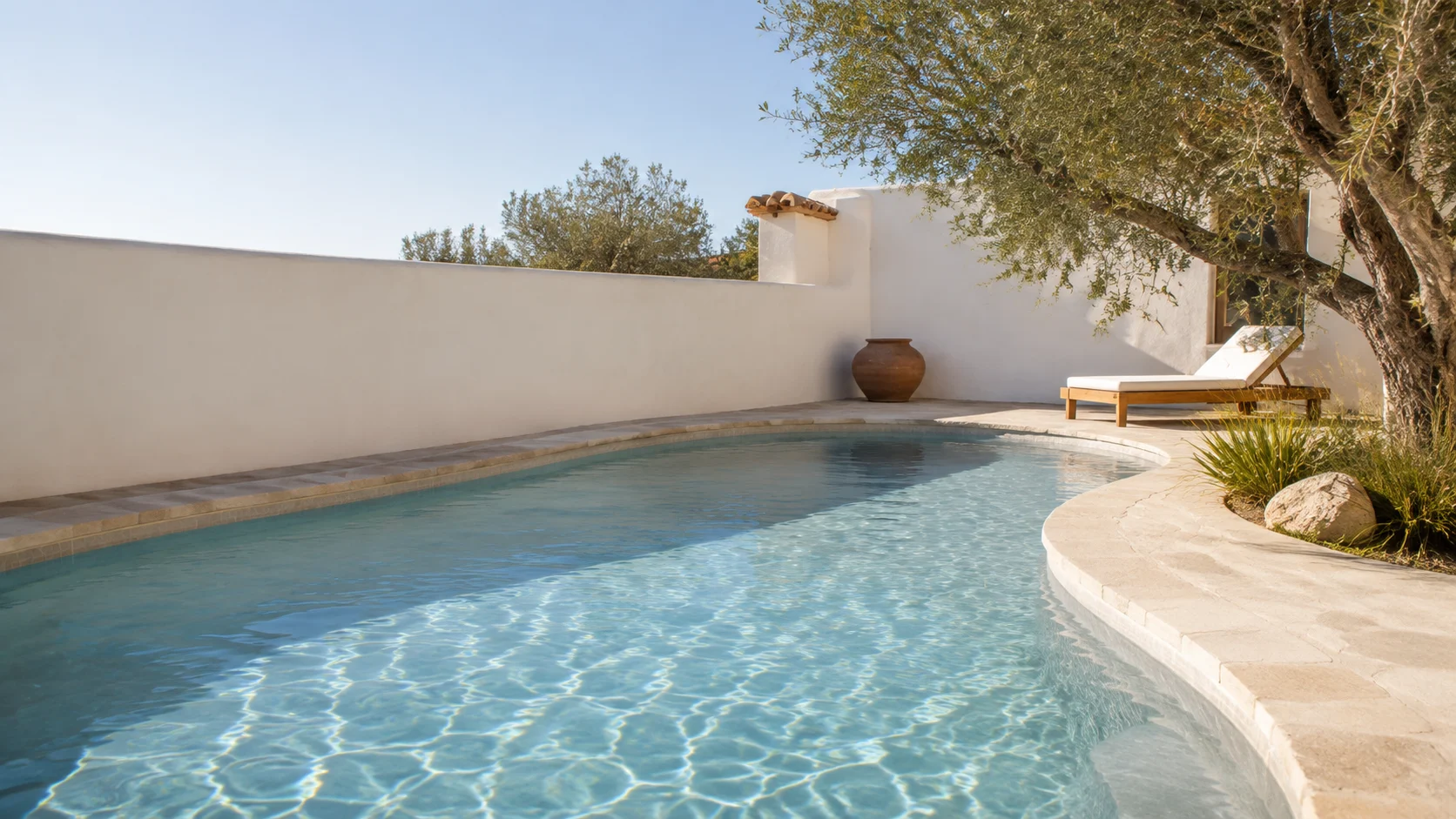 Clear blue water in a sunlit courtyard pool